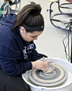girl spinning clay